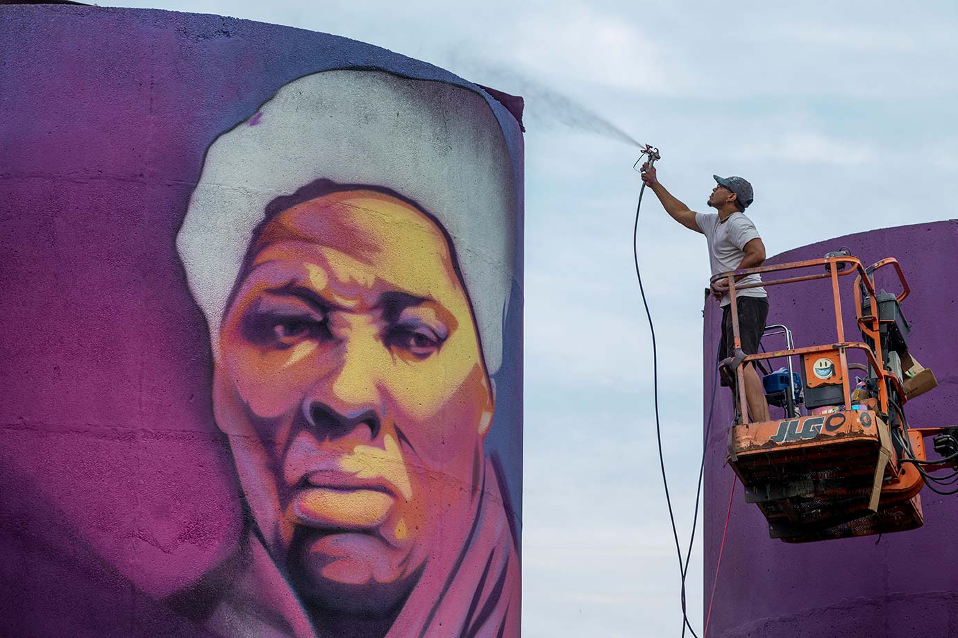 artist painting silo mural