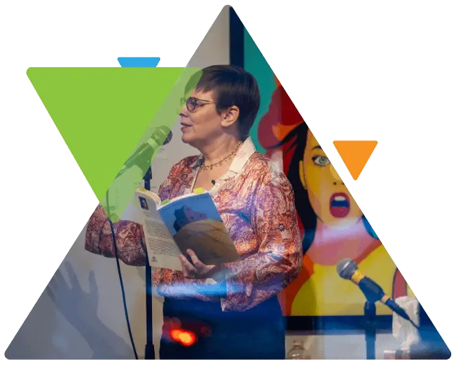A woman with glasses holds a book